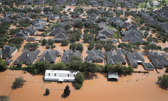 Homes are surrounded by floodwater after torrential rains pounded Southeast Texas following Hurricane and Tropical Storm Harvey on 31 August 2017 in Sugar Land, Texas. Photo: Scott Olson / Getty Images