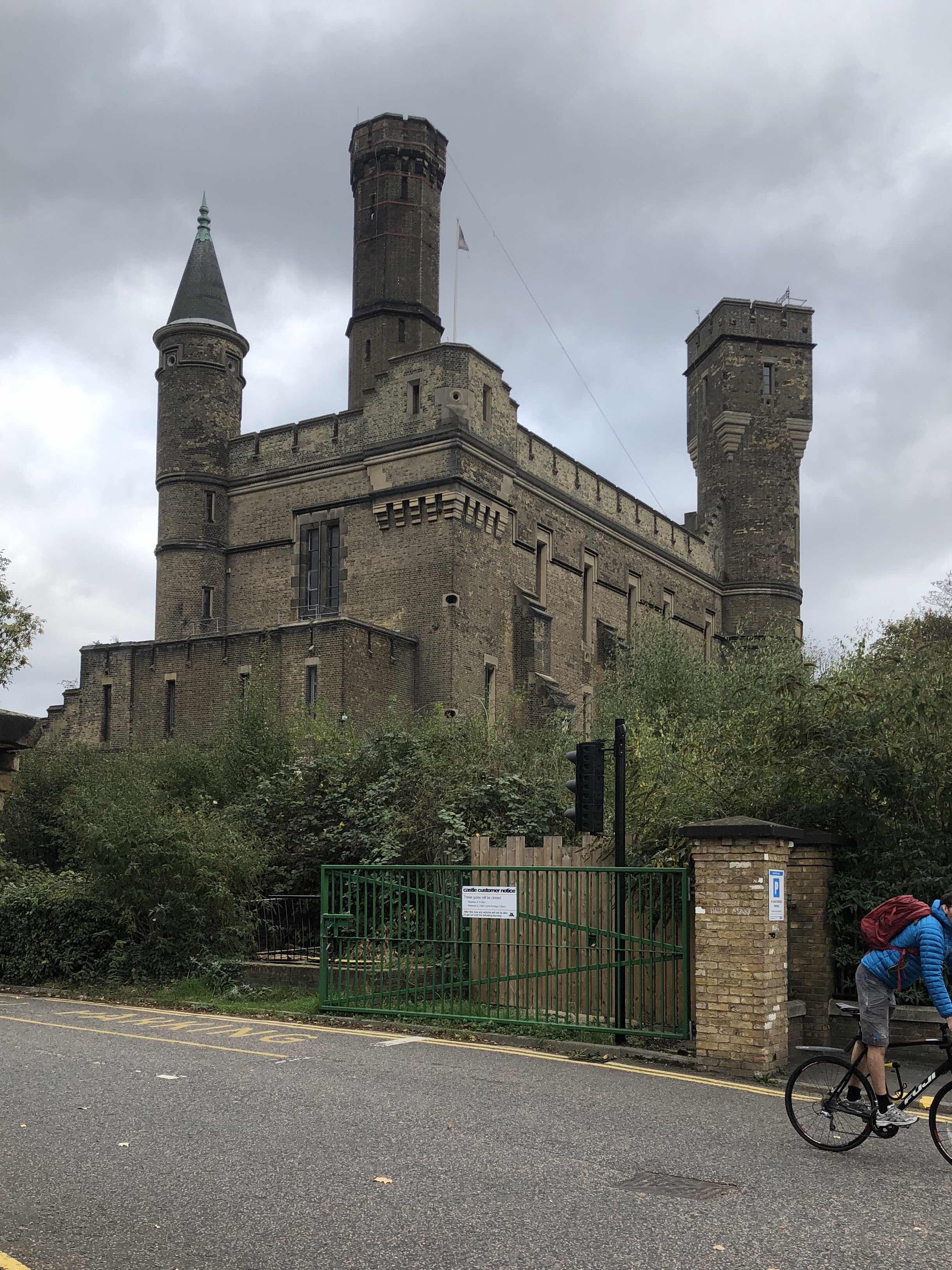 The imposing castle Climbing Center, apparently an old water pumping station, seen from the outside. It appears to have a tall tower or chimney in the middle.  