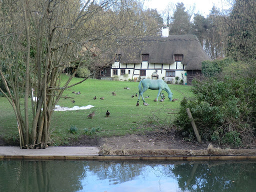 CIMG6143 Thatched cottage (and sculpture) across the Basingstoke Canal