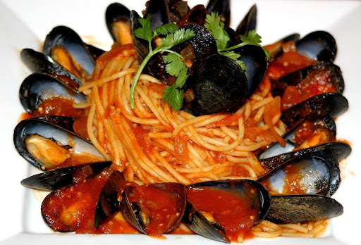 Fresh mussels simmered in a tomato-herb broth & served over angel hair pasta with just a hint of spice!