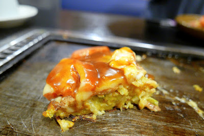 Dinner of okonomiyaki in Namba, Osaka at Ajinoya. He had the okonomiyaki with fresh tomatoes and cheese