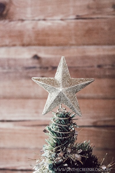 Decorating a small tree for Christmas using a tiny galvanized pot & Dollar Tree ornaments, tinsel & lights!