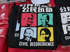 shirt with faces of famous global activists and the words "Civil Disobedience"