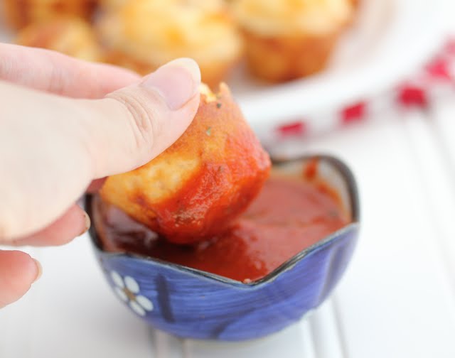 photo of a Pepperoni Pizza Puff being dipped in sauce