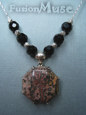 5. Leopard Jasper and Sterling Silver. A One of a Kind Octagonal Leopard Jasper stone sits central in this lovely necklace. The surrounding beads are shiny faceted Black Onyx and Karen Fine Silver. The long box Sterling Silver  chain is approx 18 inches long and has an easy to use lobster spring clasp. The matching earring (not pictured here) featured the same shiny Black Faceted Onyx and sway as you move.