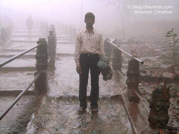 My friend Pramod is posing on the downstairs to Bhimashankar temple. Rainwater has created water streams on steps too. Bhimashankar is a rare Indian temple as reaching there is to climb down.