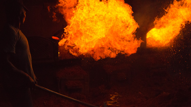 A man burns old palm fruit in Cameroon. Photo: Go Forth Films