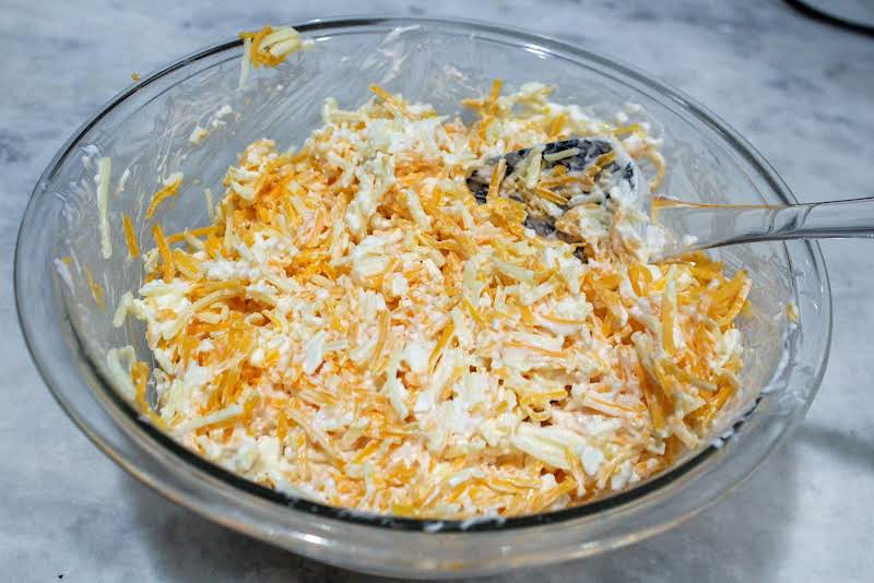 Cheese, Sour Cream, And Cottage Cheese Combined In A Bowl.