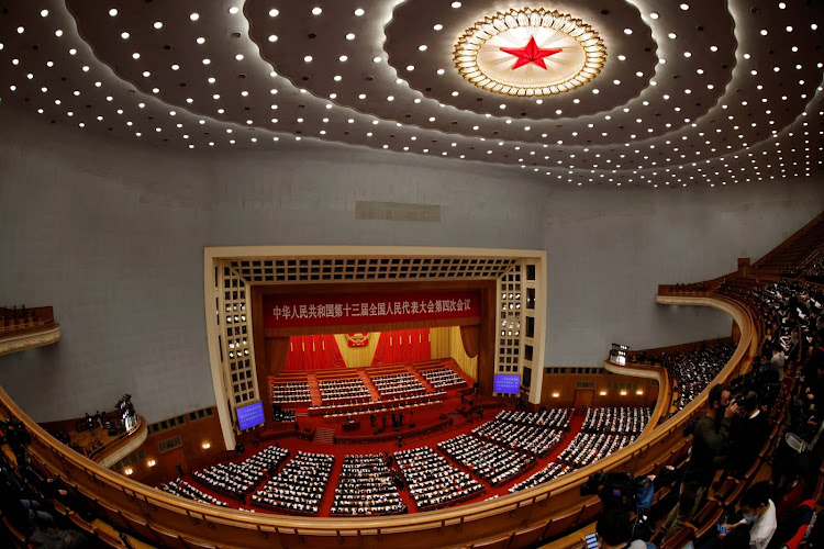 Chinese leaders and delegates attend the opening session of the National People's Congress at the Great Hall of the People in Beijing on Friday.