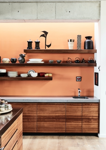 This pale coral shade paired perfectly with the rich iroko wood cabinets in this open-plan mountainside home, while giving it a cozy, cabin-like look and feel.