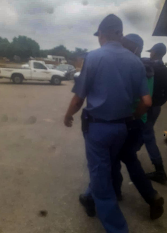 A screenshot from a video taken by Thomas Themba of police arresting Tumelo Oriel Sompane.