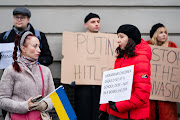 People gather in protest near the Russian embassy in Copenhagen, Denmark, after Russian President Vladimir Putin launched a military operation in eastern Ukraine on Thursday.