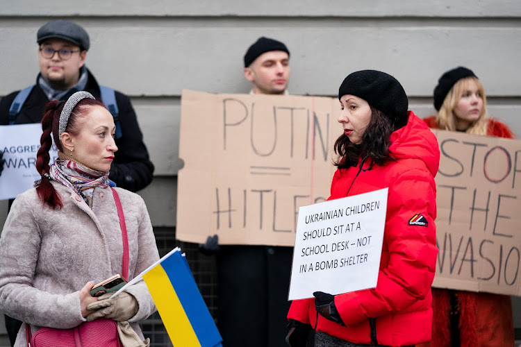 People gather in protest near the Russian embassy in Copenhagen, Denmark, after Russian President Vladimir Putin launched a military operation in eastern Ukraine on Thursday.