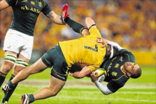 IN THE WARS: Michael Hooper of the Wallabies tackles Springbok winger Bryan Habana during The Rugby Championship match between Australia and South African at Suncorp Stadium in Brisbane. Photo: Getty Images