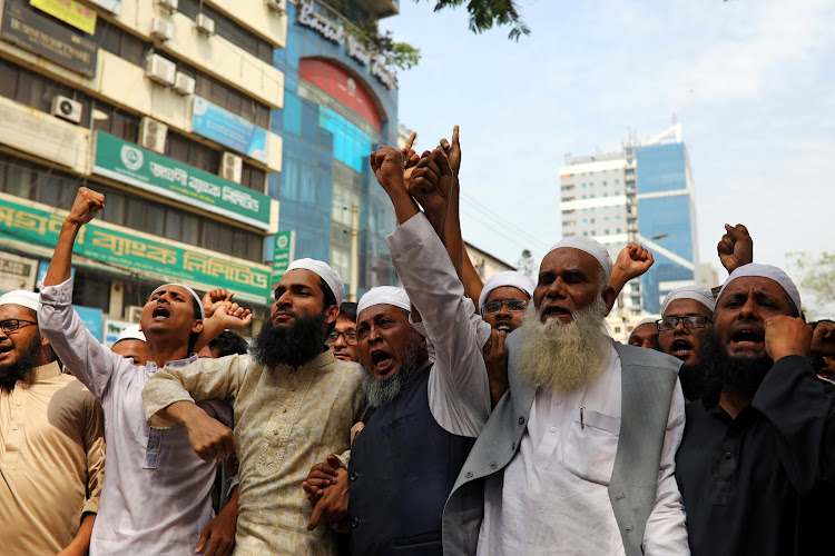 Muslims shout slogan as they condemn Christchurch mosque attack in New Zealand, after Friday prayers at the Baitul Mukarram National Mosque in Dhaka, Bangladesh, March 15, 2019.