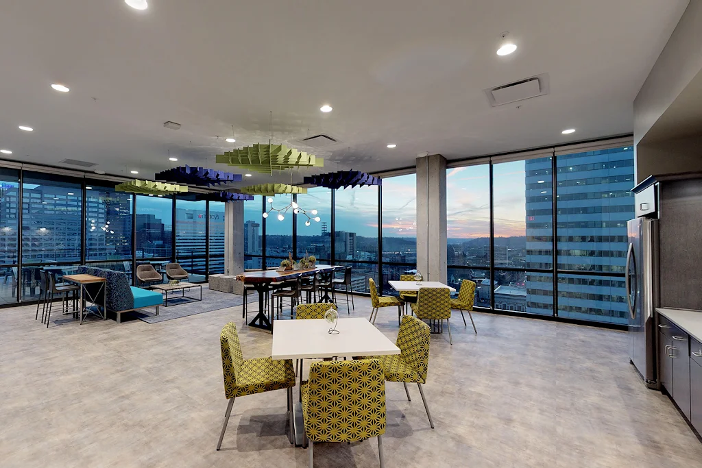 Community clubhouse with a kitchen, lounge areas, and beautiful city views