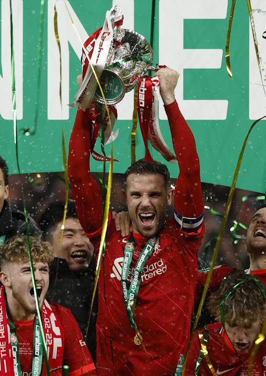 Liverpool's Jordan Henderson lifts the trophy as they celebrate winning the Carabao Cup