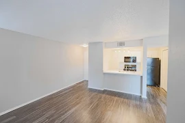 Open concept living area with wood inspired flooring and a light neutral color scheme throughout