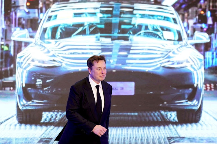 Tesla Inc CEO Elon Musk walks next to a screen showing an image of Tesla Model 3 car during an opening ceremony for Tesla China-made Model Y program in Shanghai, China January 7 2020. REUTERS/ALY SONG