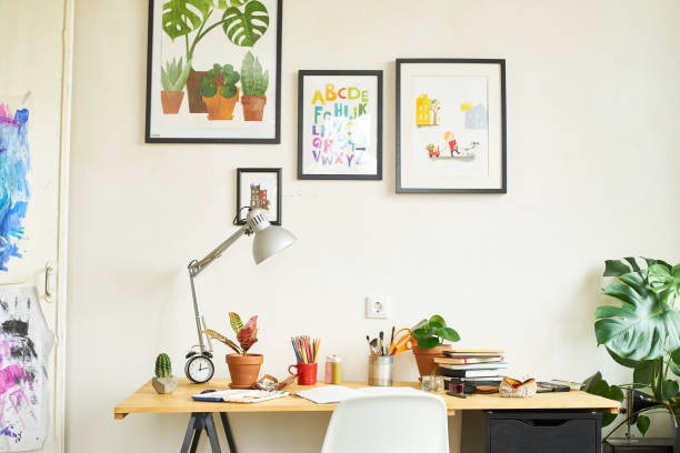 brown study table with drawers and paintings 