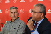 Ajax Cape Town cheif executive Ari Efstathiou (L) looks on alongside the club's legal representative Norman Arendse (R) during the Ajax press conference at Ikamva on July 27, 2018 in Cape Town, South Africa. 