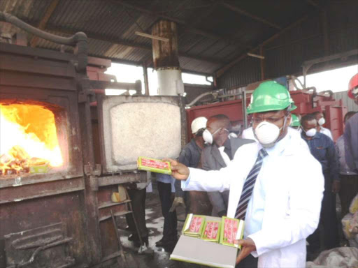 Kenya Bureau of Standards KEBS MD Charles Ongwae prepares to throw impounded mathematical sets into burning kiln at EPZ A in Athi River. /FILE