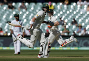 Australia v South Africa - Third Test cricket match - Adelaide Oval, Adelaide, Australia - 27/11/16. Australian batsman David Warner (R) and Matthew Renshaw run down the pitch during the fourth day of the Third Test cricket match in Adelaide. REUTERS/Jason Reed