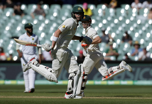 Australia v South Africa - Third Test cricket match - Adelaide Oval, Adelaide, Australia - 27/11/16. Australian batsman David Warner (R) and Matthew Renshaw run down the pitch during the fourth day of the Third Test cricket match in Adelaide. REUTERS/Jason Reed