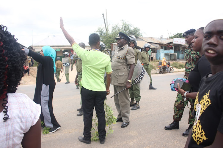 Haki Africa deputy executive director Salma Hemed (in Buibui) and Ganze subcounty police commander Timothy Muasya on Friday February 7, 2020