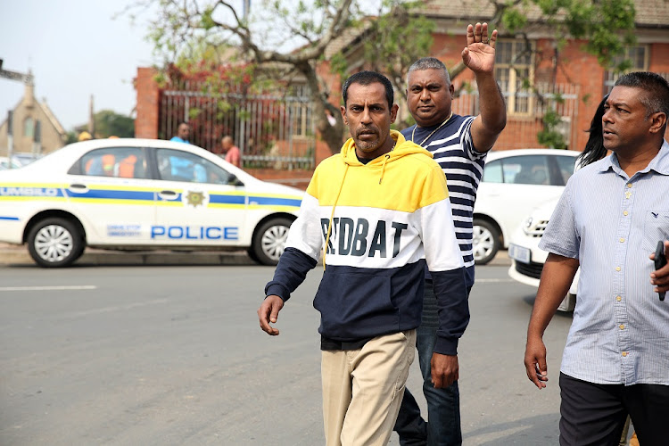 (Yellow sweater) Sagren Govindsamy father and husband of the three that were killed in Phoenix last Friday outside the Verulam Magistrate's court on Tuesday.