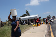 People fetch water from a tanker during a strike by SA Municipal Workers' Union members in Ugu municipality in November 2017. The area is still suffering water shortages and residents are fed up.