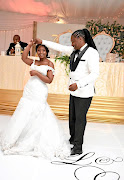 Liza and her husband Lonwabo Mbana  dance at their  wedding ceremony.