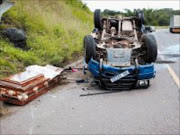 AFTERMATH: Emergency workers inspect the scene of the accident after a coffin was flung open on the N2 in Durban. Pic. Mhlaba Memela. 28/01/08. © Sowetan.