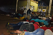 Students who were not allocated residences at DUT because they are not vaccinated sleep on the pavement outside the entrance.