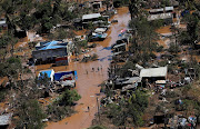 Locals affected by Cyclone Idai walk on flooded land in Buzi district outside Beira, Mozambique, March 21, 2019. REUTERS/Siphiwe Sibeko