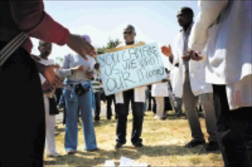 RESOLUTE: Some of the doctors who were threatened with dismissal last month after they went on strike and demonstrated outside the Dr George Mukhari Hospital in GaRankuwa in North West. 23/04/2009. Pic. Daniel Born. © Unknown.