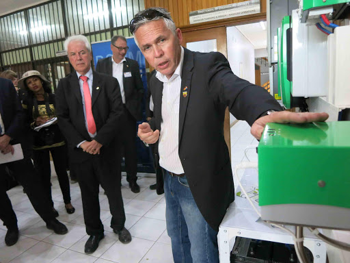 GREEN MACHINE: Buffalo City Metro electricity contracts manager Jean Smit shows a German official a prototype of a solar-powered system at a launch of BCM’s green Nakopa Project in Beacon Bay last night Picture: MIKE LOEWE