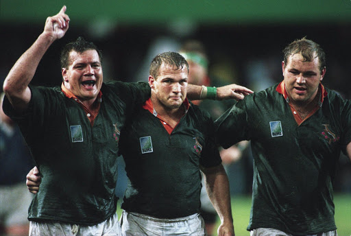 DURBAN, SOUTH AFRICA: 17 June 1995, Balie Swart, Chris Rossouw and Pieter du Randt celebrate during the semi-final rugby world cup match between South Africa and France held at Kings Park stadium in Durban, South Africa. Photo by Allsport / Gallo Images.