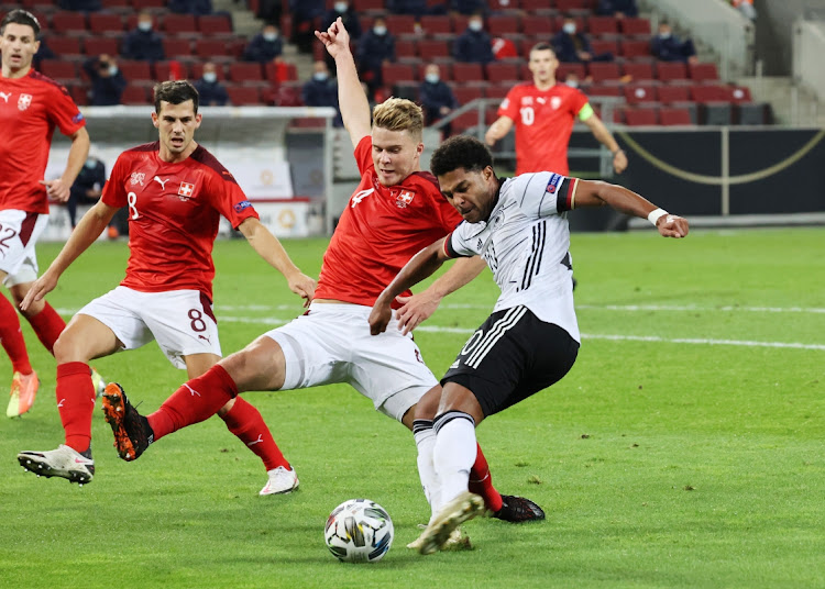 Germany's Serge Gnabry shoots on goal while Switzerland's Nico Elvedi attempts to block in their UEFA Nations League A, Group 4 match at RheinEnergieStadion, Cologne on October 13, 2020