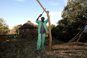 Collecting firewood is one of the tasks 80-year-old Mpiyesende Ngcobo undertakes each day to keep warm and cook. 