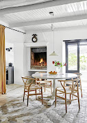 The indoor living and dining room lead to their outdoor counterparts on the verandah, this inside option being preferred in winter, when the fireplace roars.