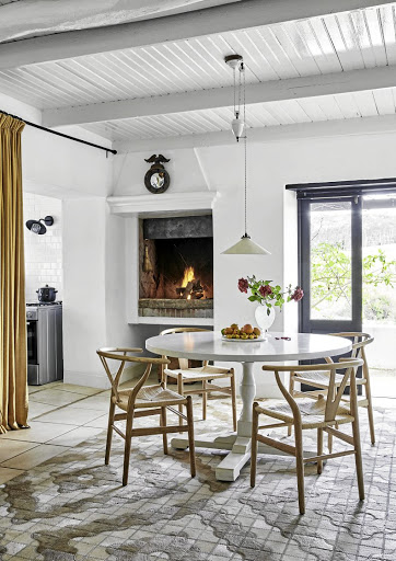 The indoor living and dining room lead to their outdoor counterparts on the verandah, this inside option being preferred in winter, when the fireplace roars.