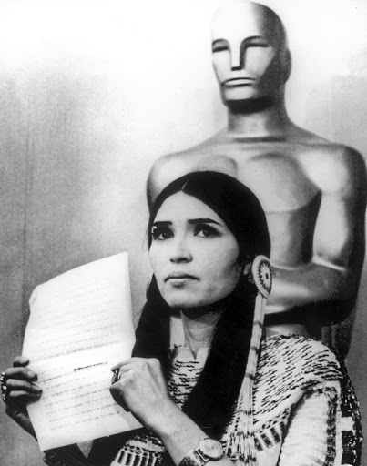 Marlon Brando continued to scrape away at the surface allure of the Oscars in 1973 when he refused to accept his Oscar in person, instead sending Native American actress Sacheen Littlefeather to accept it on his behalf.