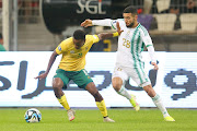 Bafana Bafana's Themba Zwane holds off Ahmed Kendouci of Algeria in the Fifa Series international friendly at Stade Nelson Mandela in Algiers on Tuesday night.