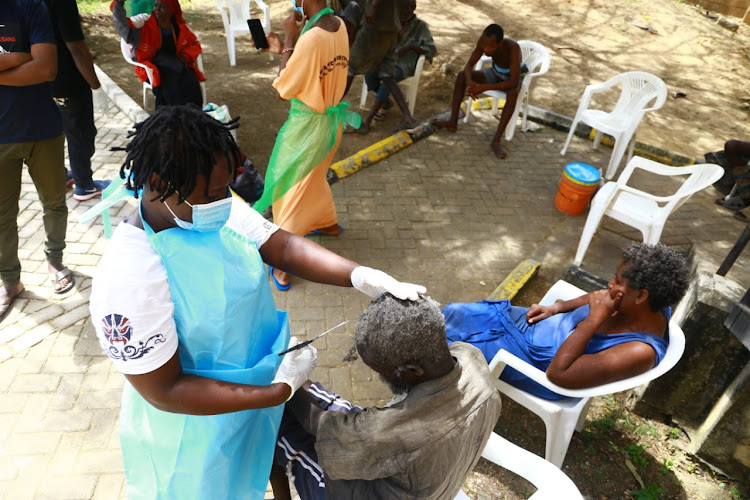 A man gets a haircut upon arrival at a mental facility at the KCNP in Mombasa on Wednesday.