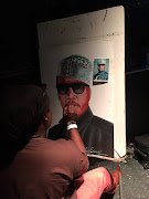 Celebrity funeral artist Lebani Sirenje aka Rasta working on a painting of the late rapper