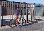Ceelo Mann (8) on his bike with his books headed to the library.