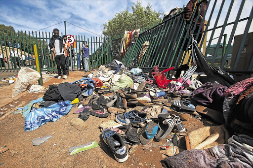 Shoes, umbrellas and clothing at the entrance to the University of Johannesburg's Bunting Road campus after a stampede left a women dead and 16 people injured Picture: HALDEN KROG