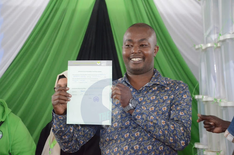 MP-elect Benjamin Gathiru displays his election certificate