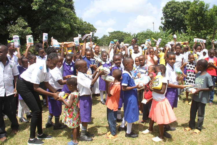 Maryjoy Kindergarten and Primary Grade 3 learners giving the donated foodstuffs to the needy children at the Mother’s Vision Children Rescue Center in Mtwapa, Kilifi county on Saturday, September 3.